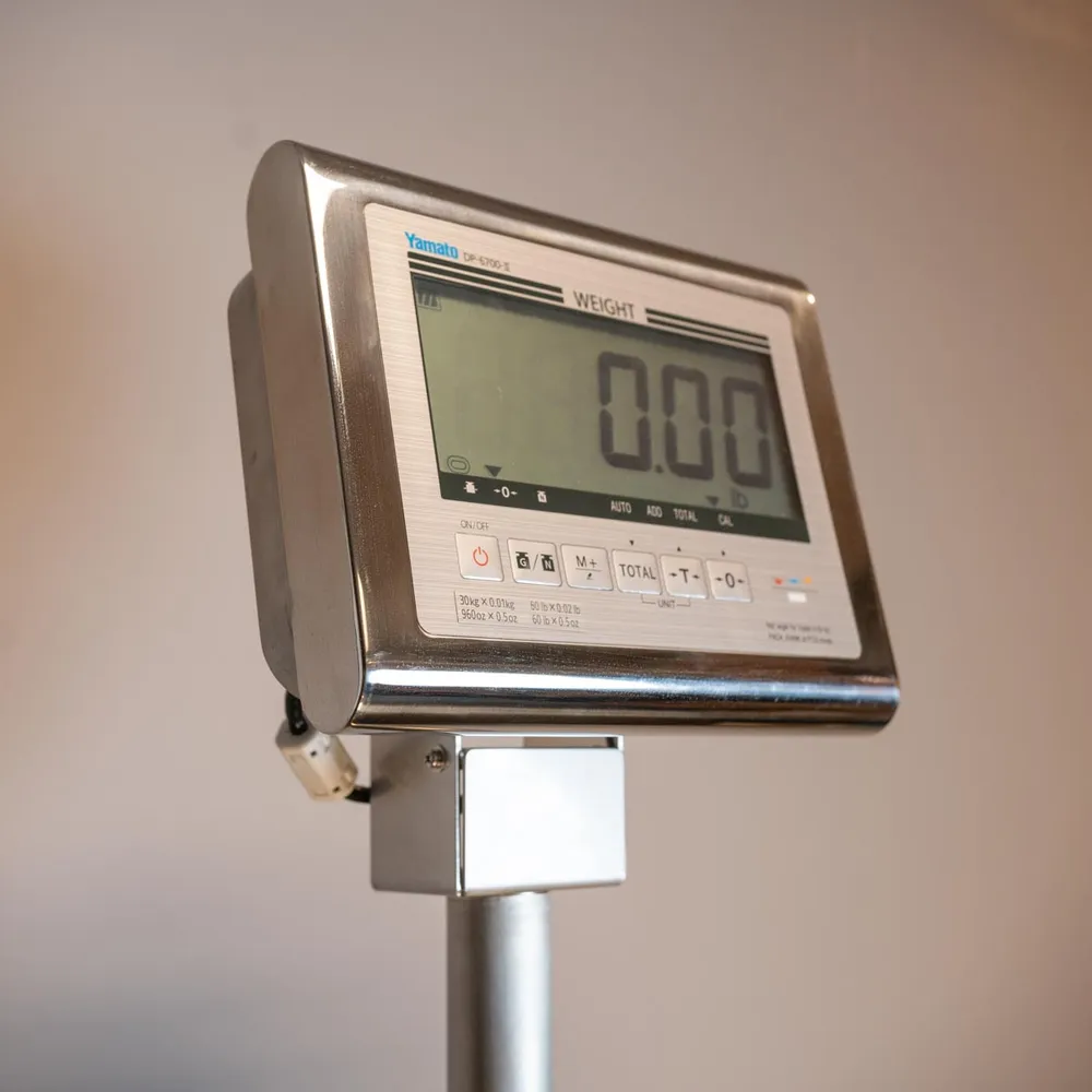 Stainless steel scale indicator on a column, reading 0.00